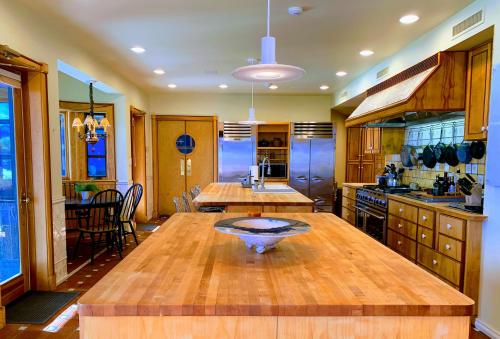 a large kitchen with a wooden table in it at NewVida Preserve in Wilmington