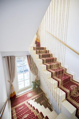 a staircase in a house with a patterned carpet at Carol Park View in Bucharest