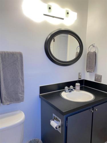 a bathroom with a sink and a mirror at Bluebird Day - River Gem Bungalow in Bend