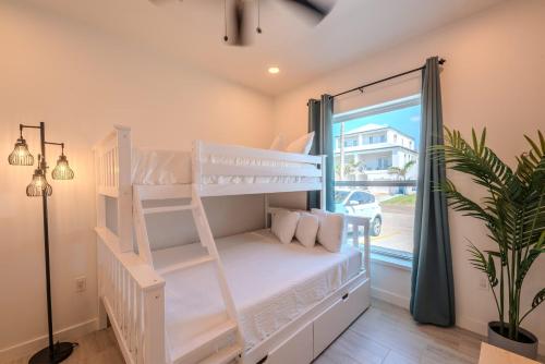 a bedroom with two bunk beds and a window at Marisol 101 in South Padre Island