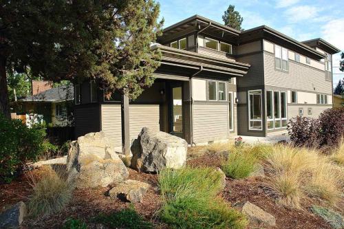 a large house with rocks in front of it at Bluebird Day - High Desert Dwell in Bend