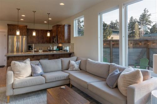 a living room with a couch and a kitchen at Bluebird Day - High Desert Dwell in Bend