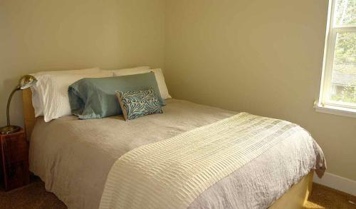 a bedroom with a bed with two pillows on it at Bluebird Day - High Desert Dwell in Bend