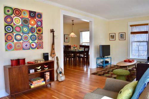un soggiorno con divano e chitarra di Bluebird Day - Jefferson Cottage a Bend