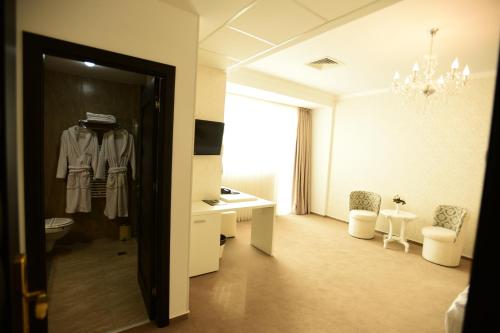 a hotel room with a robe hanging on a door at La Rocca Boutique Hotel in Craiova