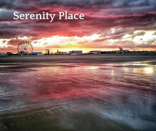 a sunset with a ferris wheel and the words security place at Serenity Place Caravan 2 Double Beds With Varanda in Skegness