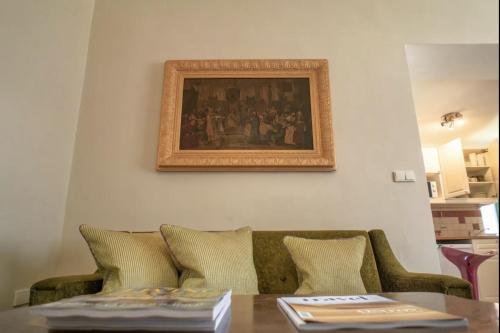 a living room with a couch and a picture on the wall at Fara Bošín in Křinec