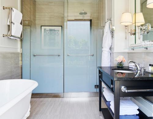 a bathroom with a glass shower door and a sink at InterContinental Paris Le Grand by IHG in Paris