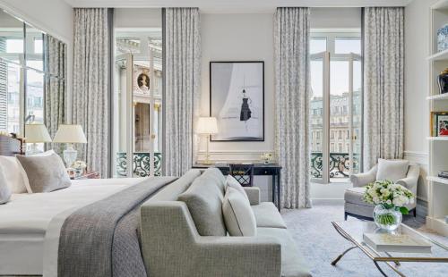 a bedroom with a large bed and a living room at InterContinental Paris Le Grand by IHG in Paris