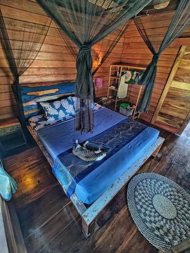 a bedroom with a bed in a wooden room at Taman Fajar Gili Asahan in Gili Asahan