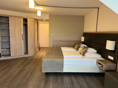 a bedroom with a large bed in a room at Flair Park Hotel Ilshofen in Ilshofen