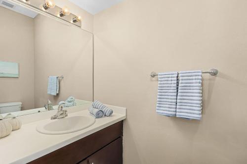 a bathroom with a sink and a mirror at Gorgeous Townhome Close to the beaches in Fort Myers