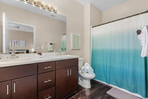a bathroom with a sink and a toilet and a shower at Modern Townhouse close to beaches in Fort Myers