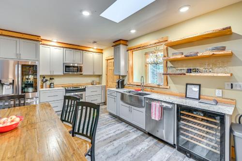 a large kitchen with a wooden table and chairs at Tree Tops Retreat about 19 Mi to Lake George! in Chestertown