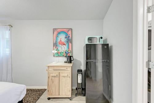 a kitchen with a refrigerator and a table with a microwave at Cozy Modernized Home - Minutes to Downtown-AUS in Austin