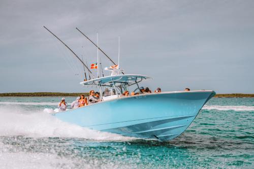 a group of people on a blue boat in the water at Valentines Resort & Marina in Harbour Island