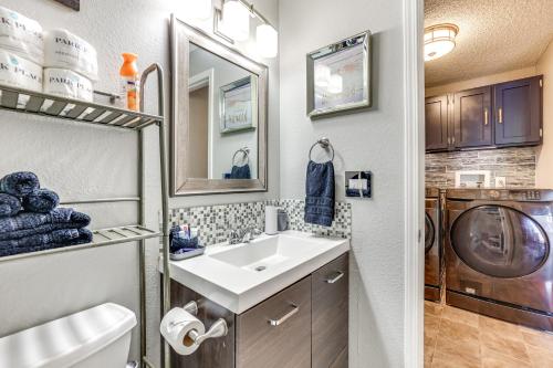 a bathroom with a sink and a washing machine at Boise Home with Hot Tub, Yard about 5 Mi to Dtwn! in Boise