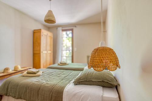 a bedroom with a bed with a lamp on it at Mas de Bacalan in Mormoiron
