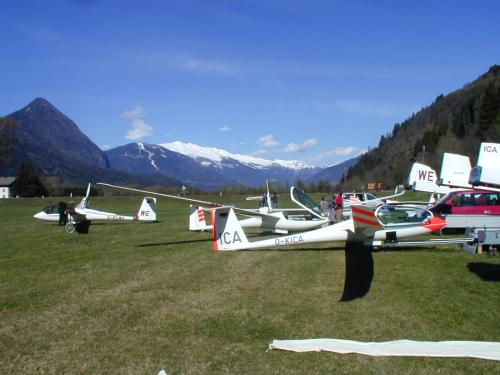 a group of planes parked in a field with mountains at Gästehaus Steinerhof in Nikolsdorf