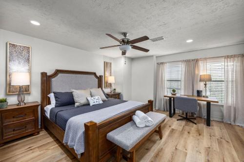 a bedroom with a bed and a ceiling fan at Walkable Montrose 2BR Music Retreat Sleeps 10 in Houston