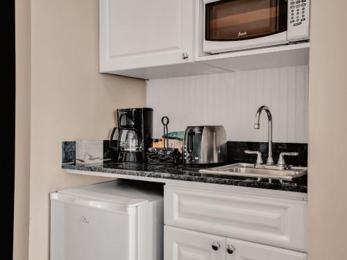 a kitchen with a sink and a microwave at Valentines Resort & Marina in Harbour Island