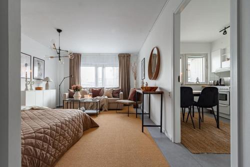 a bedroom with a bed and a living room at Budget studio in hip SoFo - construction work in Stockholm