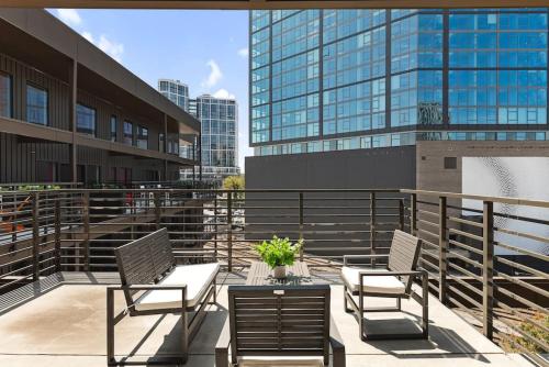 a balcony with two chairs and a table and some buildings at Luxury Penthouse with 2 Floors Pool Patio Gym Walk to Broadway in Nashville