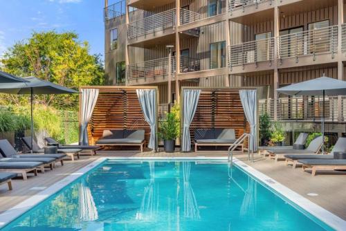 a pool at a hotel with chairs and umbrellas at Luxury Penthouse with 2 Floors Pool Patio Gym Walk to Broadway in Nashville