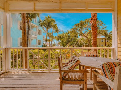 a porch with a table and chairs on a deck at Valentines Resort & Marina in Harbour Island