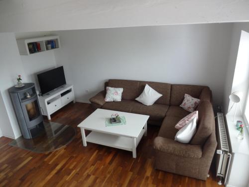 a living room with a couch and a coffee table at Ferienhaus Anna in Greetsiel