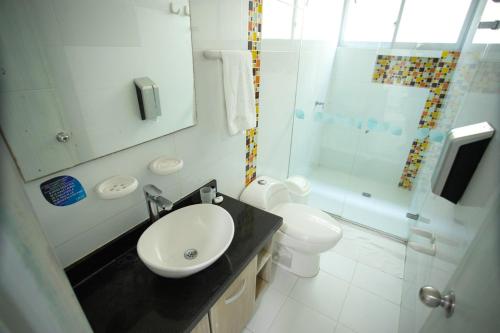 a bathroom with a sink and a toilet and a shower at Hotel Poblado Coveñas in Coveñas