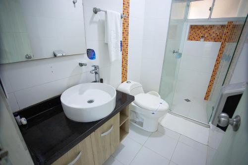 a bathroom with a sink and a shower and a toilet at Hotel Poblado Coveñas in Coveñas