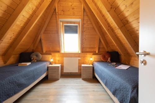 two beds in a room with a attic at Ferienhaus "Happy Krabbe" Mellumplate 31 in Dorum Neufeld