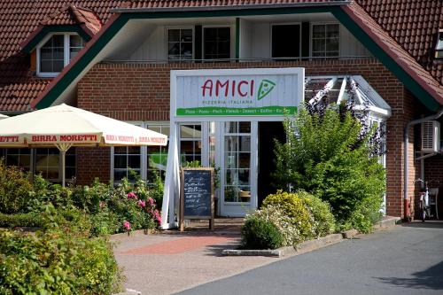 a store front of a brick building with a sign at Cuxlandhotel Doppelzimmer 117 in Dorum Neufeld