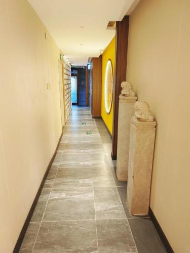 a hallway with two stone columns in a building at Qinfu Hotel Beijing Nanluogu Lane Houhai in Beijing