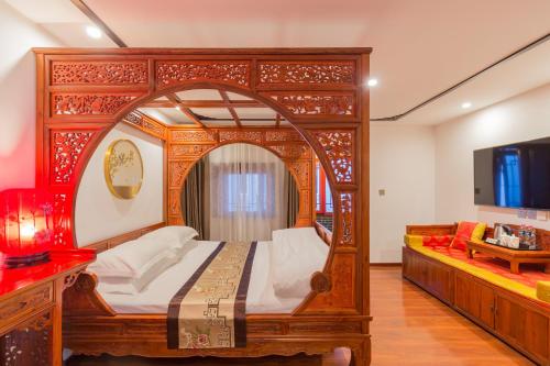 a bedroom with a large wooden bed with a mirror at Qinfu Hotel Beijing Nanluogu Lane Houhai in Beijing