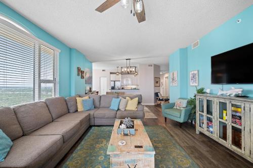 a living room with a couch and a tv at Beach Colony East 14D in Pensacola