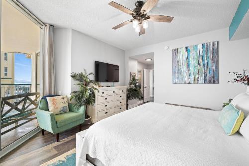 a bedroom with a bed and a flat screen tv at Beach Colony East 14D in Pensacola