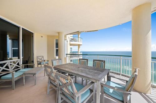 a dining table and chairs on a balcony with the ocean at Beach Colony East 14D in Pensacola