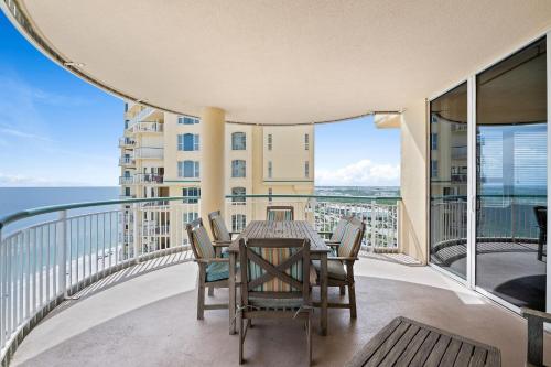 a balcony with a table and chairs and the ocean at Beach Colony East 14D in Pensacola