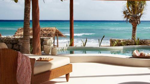 a swimming pool with a view of the ocean at Viceroy Riviera Maya, a Luxury Villa Resort - Adults Only in Playa del Carmen