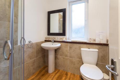 a bathroom with a toilet and a sink at Lamlash Bay Hotel in Lamlash