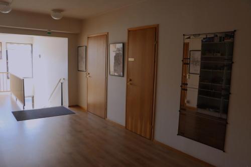 a room with a hallway with a door and wooden floors at E4 Recidence Tornio in Tornio