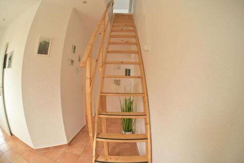 a wooden staircase in a room with a shelf at Ferienwohnung Zollverein in Essen