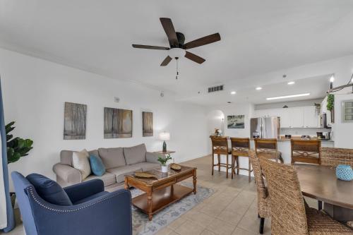 a living room with a couch and a table at 2BR condo minutes to Disney Springs in Orlando