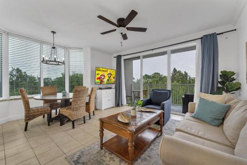 a living room with a couch and a table at 2BR condo minutes to Disney Springs in Orlando