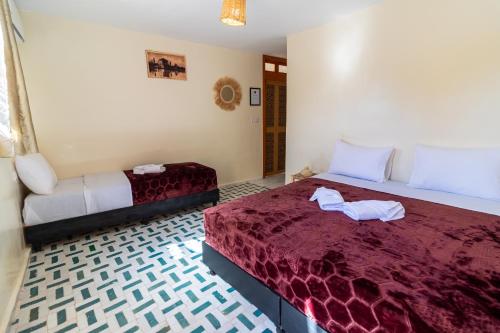Una cama o camas en una habitación de Riad Batha