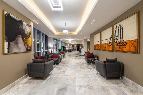 a waiting room with chairs and paintings on the walls at HDB Al Sahafa in Riyadh