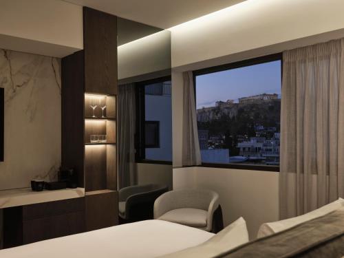 a hotel room with a bed and a window at Nur Edge Aparthotel - Acropolis Skyline in Athens