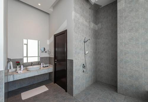 a bathroom with a shower and a sink at HDB Al Sahafa in Riyadh